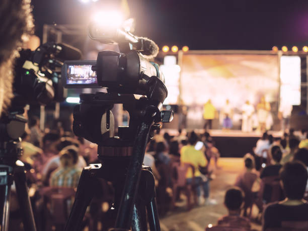 Camera behind an audience pointed at the stage.