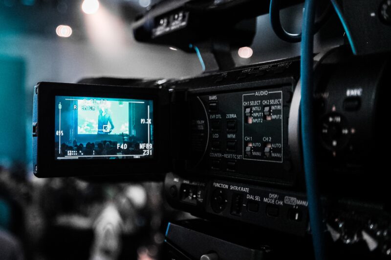 A broadcasting camera viewing a stage.